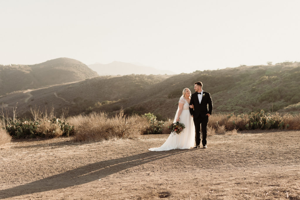top 3 tips when planning your wedding, bride and groom romantics during golden hour in the california hills