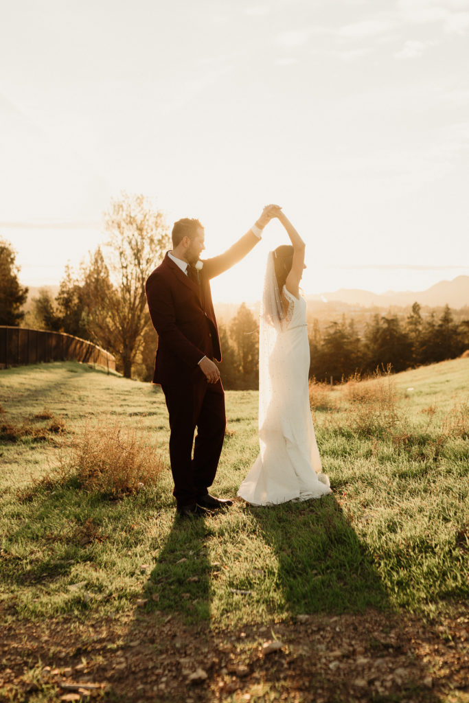 bride and groom dance in the hills of los angeles during sunset
