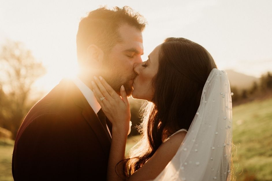 Bride and groom kiss during golden hour romantics at Thousand Oaks, CA wedding