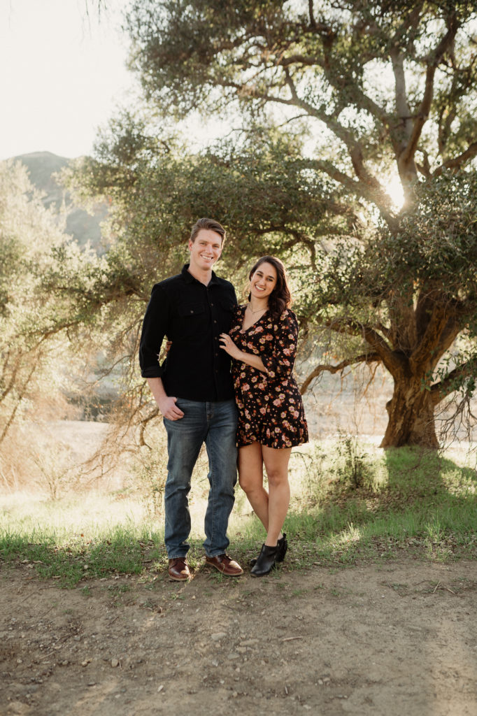 couple posing in front of an oak tree at malibu creek state park