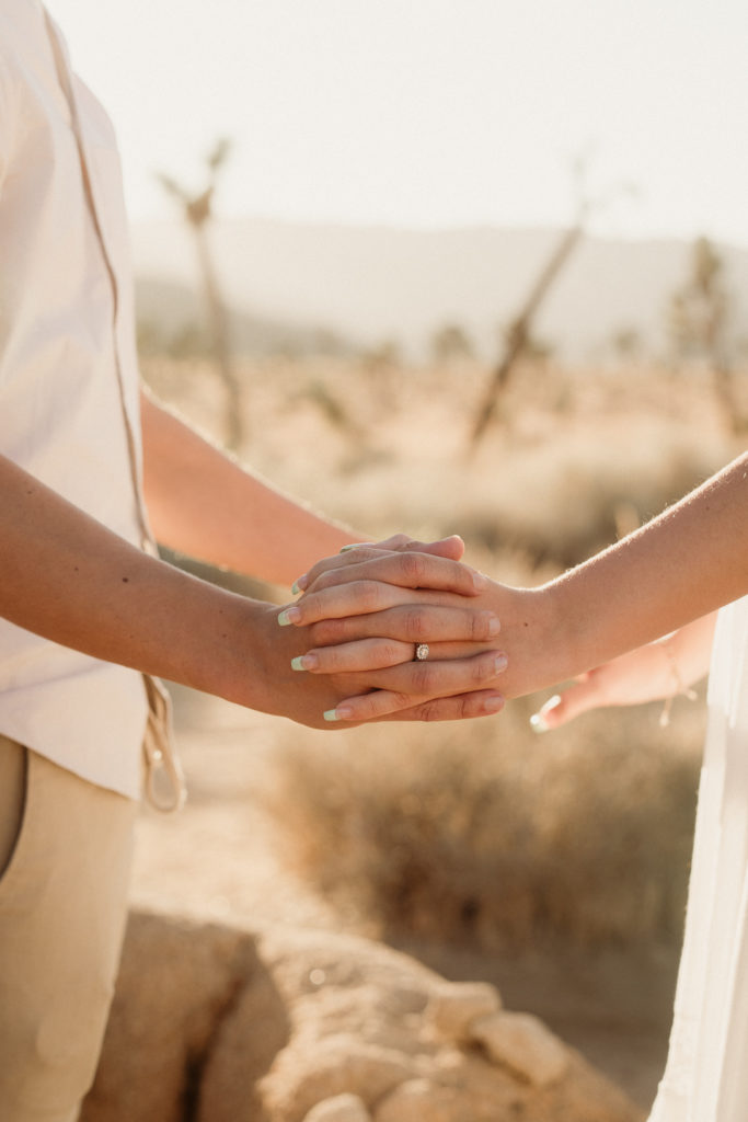 bride and groom engagement photos in joshua tree national park showing the ring