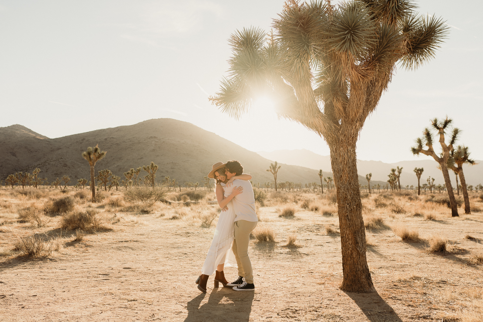 playful couple during engagement photos in joshua tree national park