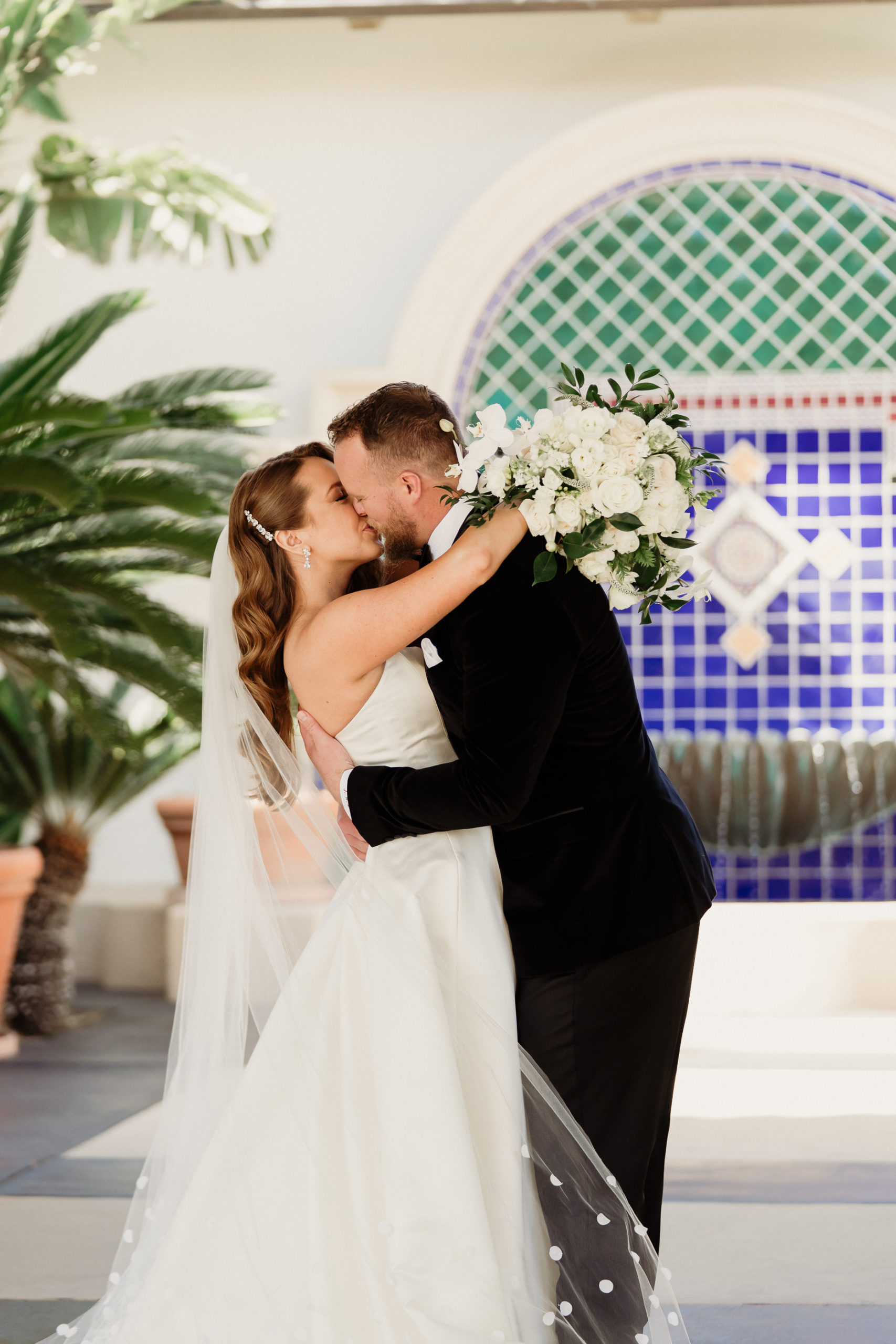 spanish hills country club wedding photographer | groom kisses bride portrait at spanish hills country club
