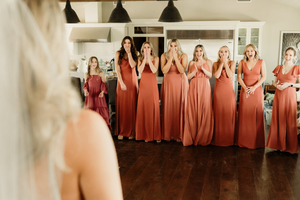 the brides first look with her bridesmaids