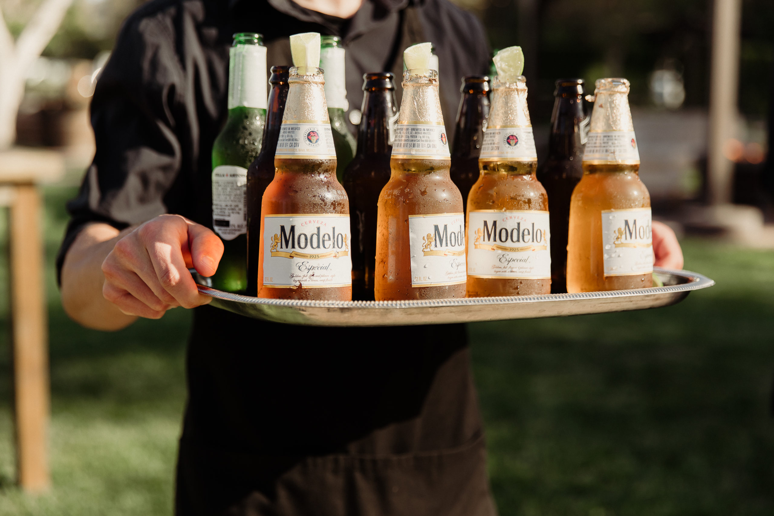 modelo beers on a tray carried by brick and brass command performance catering