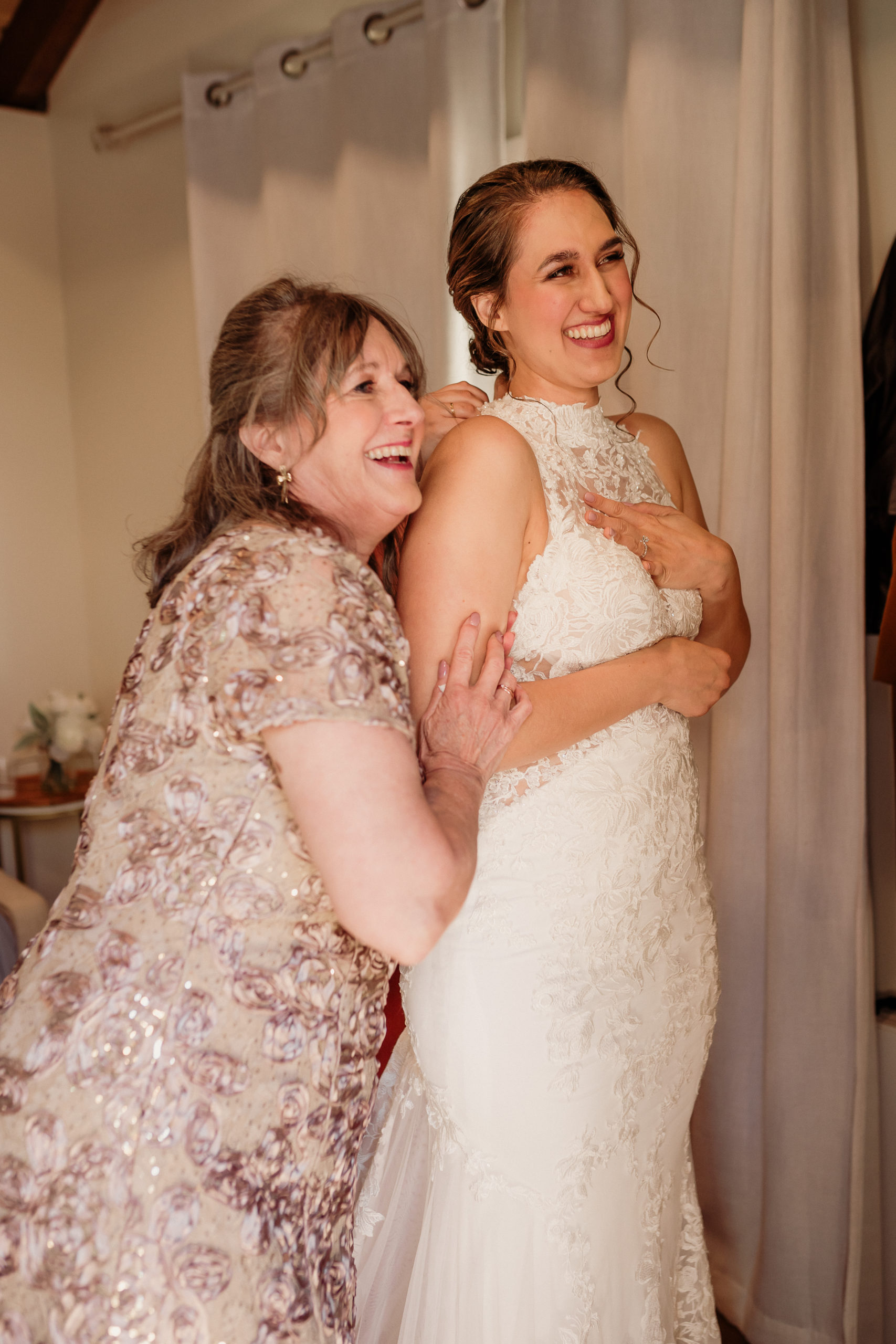 bride and her mom admire her dress in the mirror at walnut grove weddings in moorpark