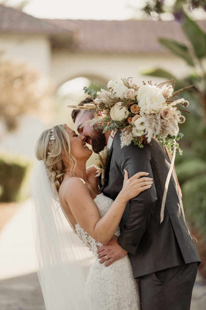 bride and groom kiss during wedding photos at spanish hills country club in camarillo, ca | spanish hills country club wedding photographer