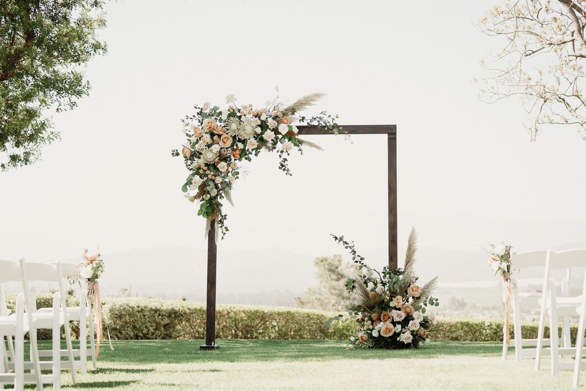 boho wedding arch with pampas grass, terracotta, blush and ivory roses