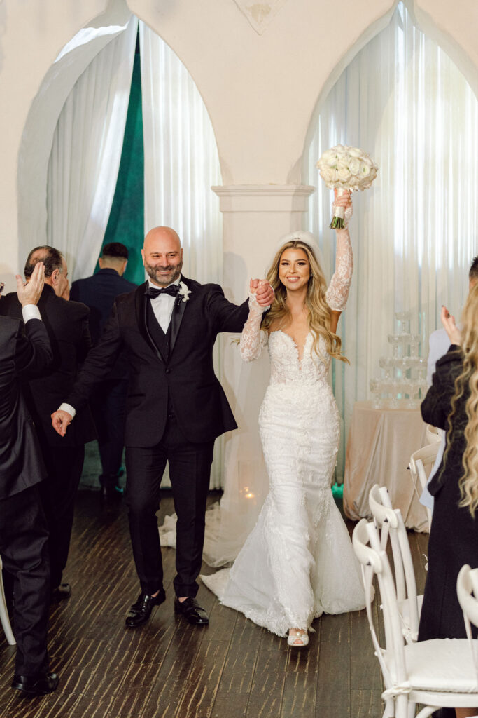 bride and groom cheer during their grand entrance at Santuari LA captured by Los Angeles wedding photographer Magnolia West Photography