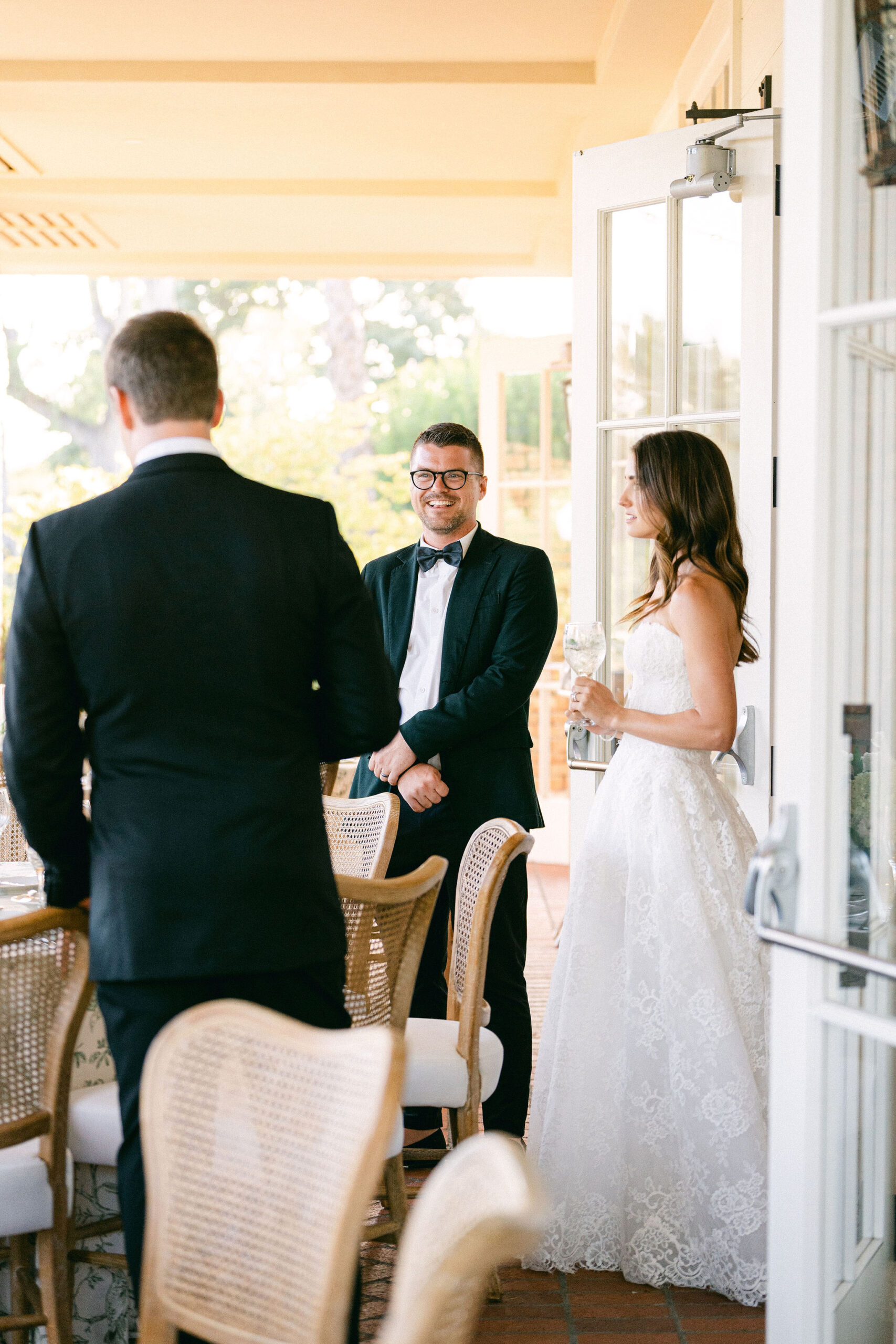 Florist and wedding planner Tyler Speier talks with bride and groom during their private reception room reveal at the Belmond El Encanto captured by Santa Barbara wedding photographer Magnolia West Photography